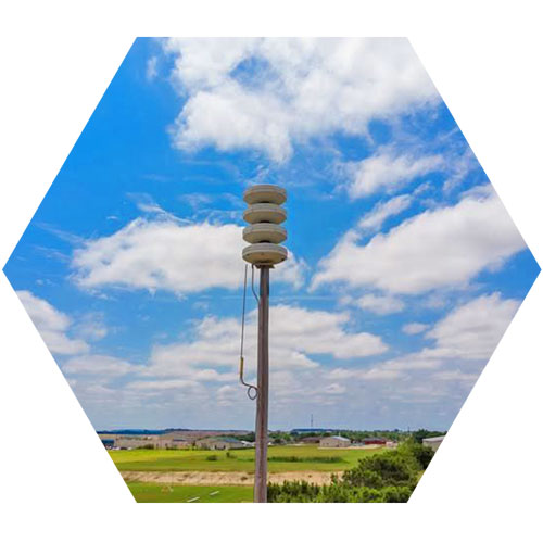 outdoor satellite against a blue sky and green grass